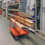 A photo of a lumber cart in a big box home improvement store, using P&H Casters Wheels.