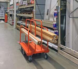 A photo of a lumber cart in a big box home improvement store, using P&H Casters Wheels.